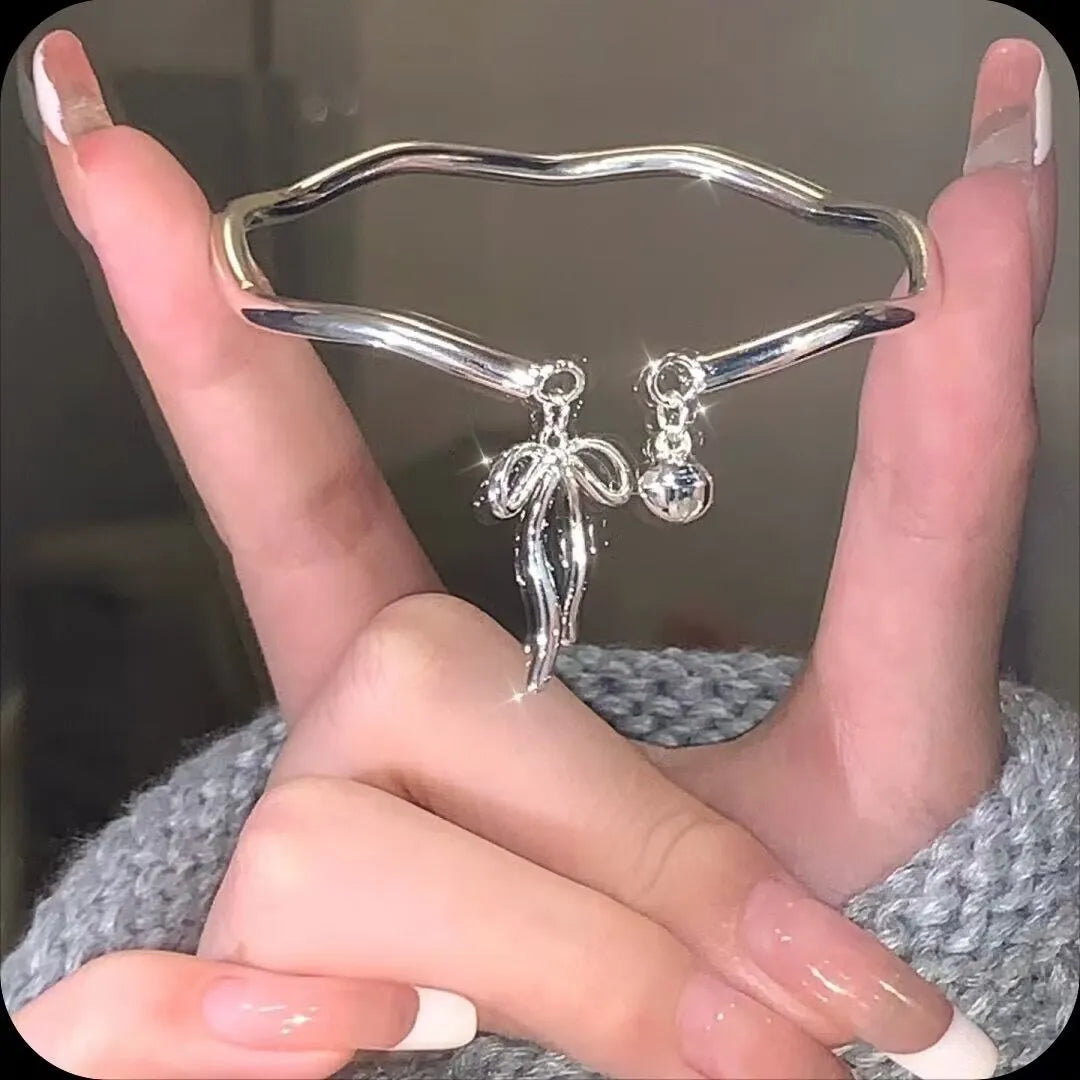 Silver adjustable bow bracelet with bowbell clasp on adjustable chain