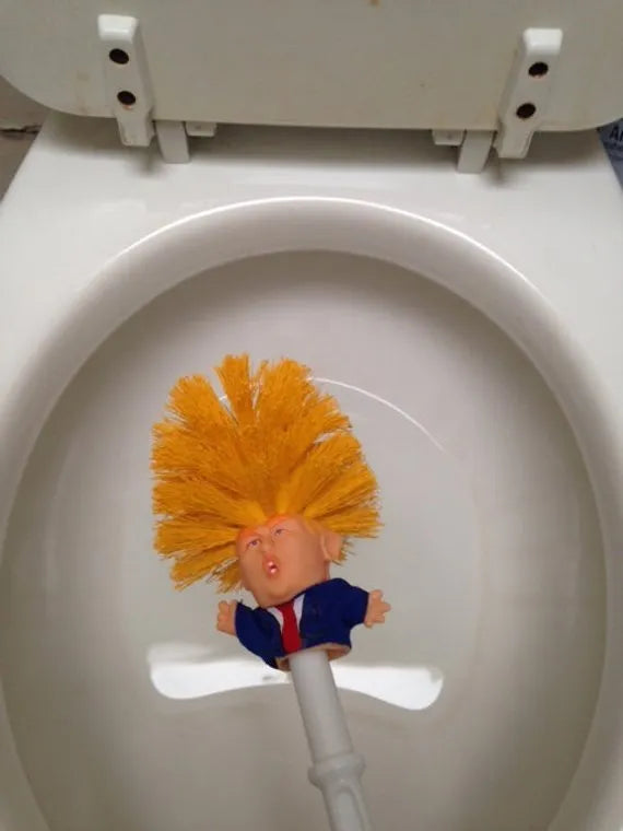Yellow plastic Donald Trump toilet brush with handle slot, 40cm length, on white background