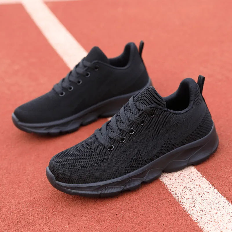 All black women's lightweight mesh sneakers with wedge heel and front lace-up design
