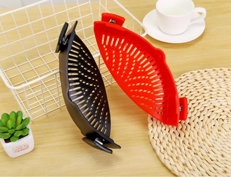 Silicone clip-on pot strainer with uniform hollow design in Red, attached to a stainless steel pot rim