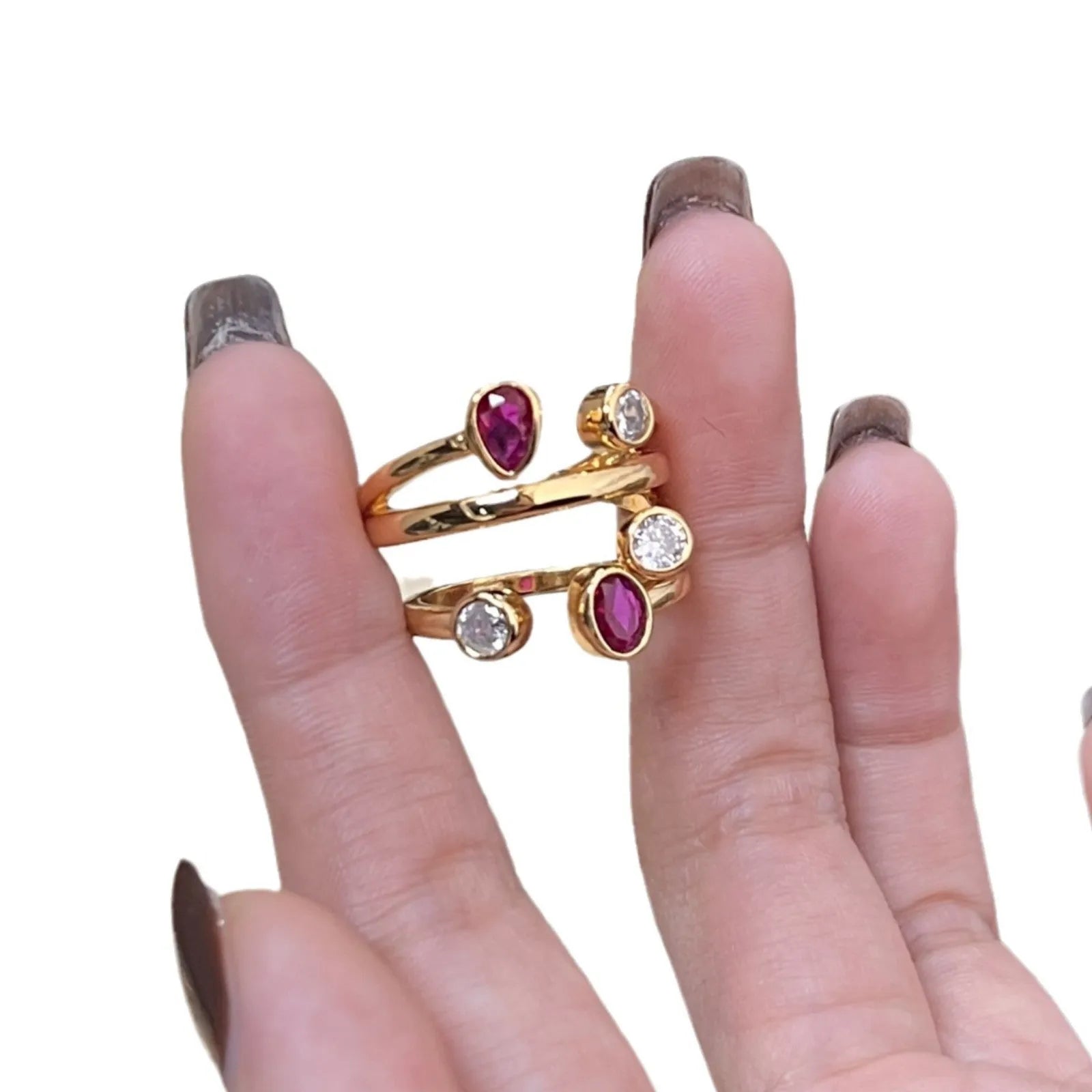 Geometric copper ring with irregular cross design in two-tone red and white colours.