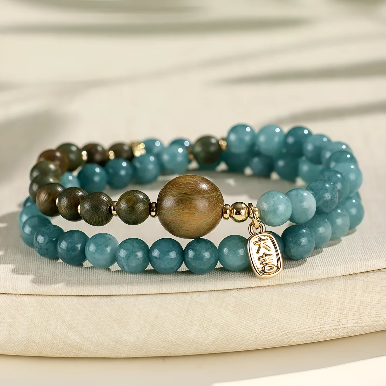 Natural stone blue beaded bracelet for women with sandalwood accents and Fu character motif