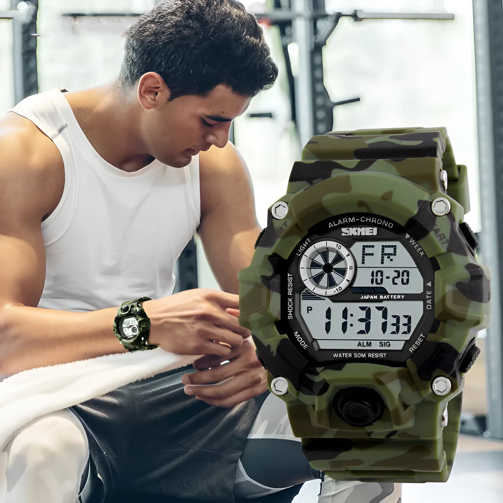 Digital sports watch with round dial, plastic strap, showing GMT display and available in army green colour.
