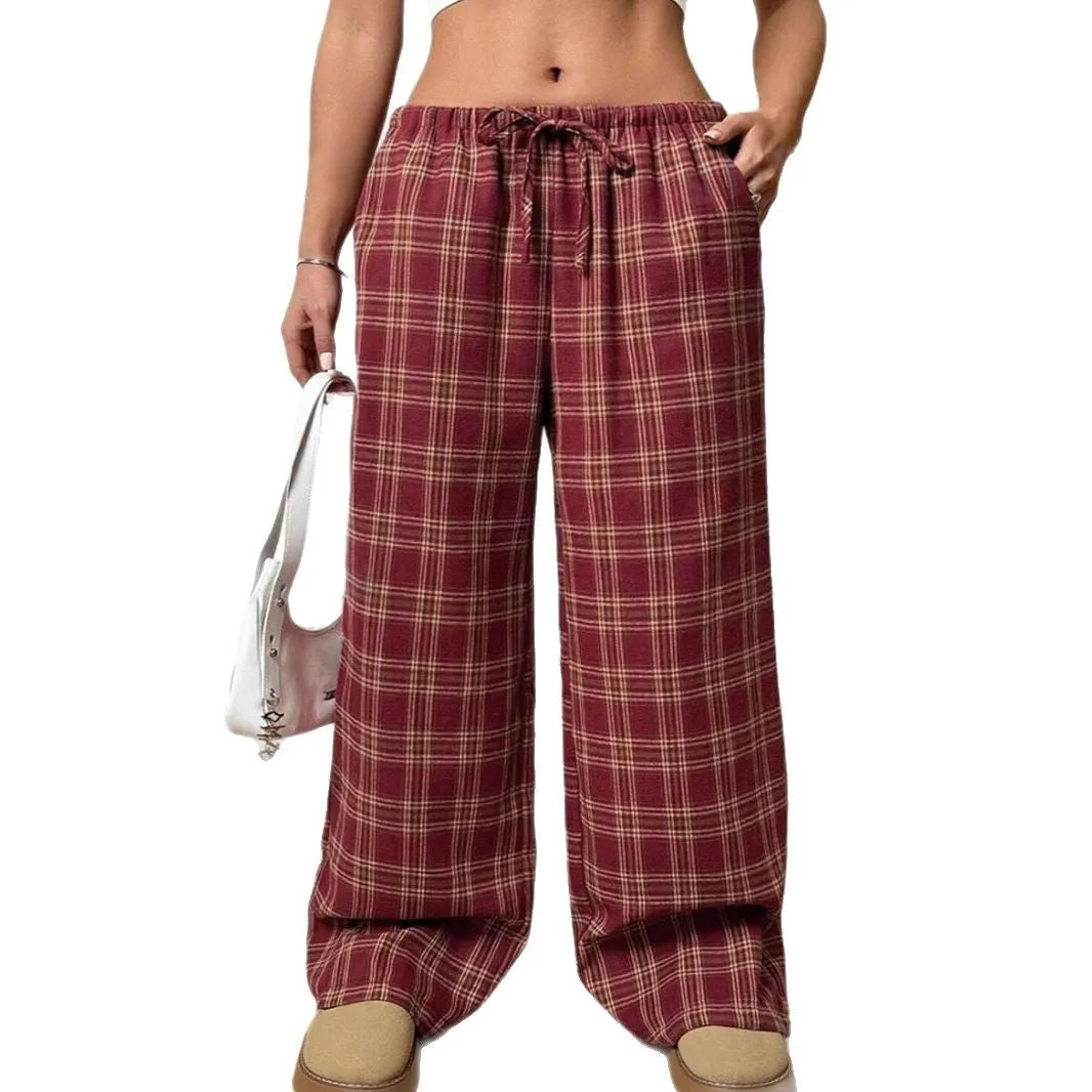 Women's red casual loose trousers with drawstring waist and plaid patch pockets laid flat.