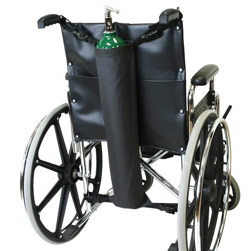 Black cylindrical oxford cloth pannier bag for securing an oxygen cylinder to a wheelchair.