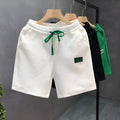 Casual micro-elastic polyester sports shorts in solid white, black, or green colours with American style design