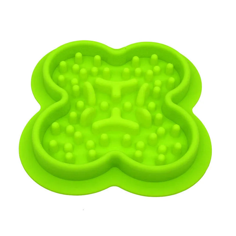 A blue silicone pet licking pad with a textured surface, placed on a wooden floor.