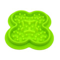 A blue silicone pet licking pad with a textured surface, placed on a wooden floor.