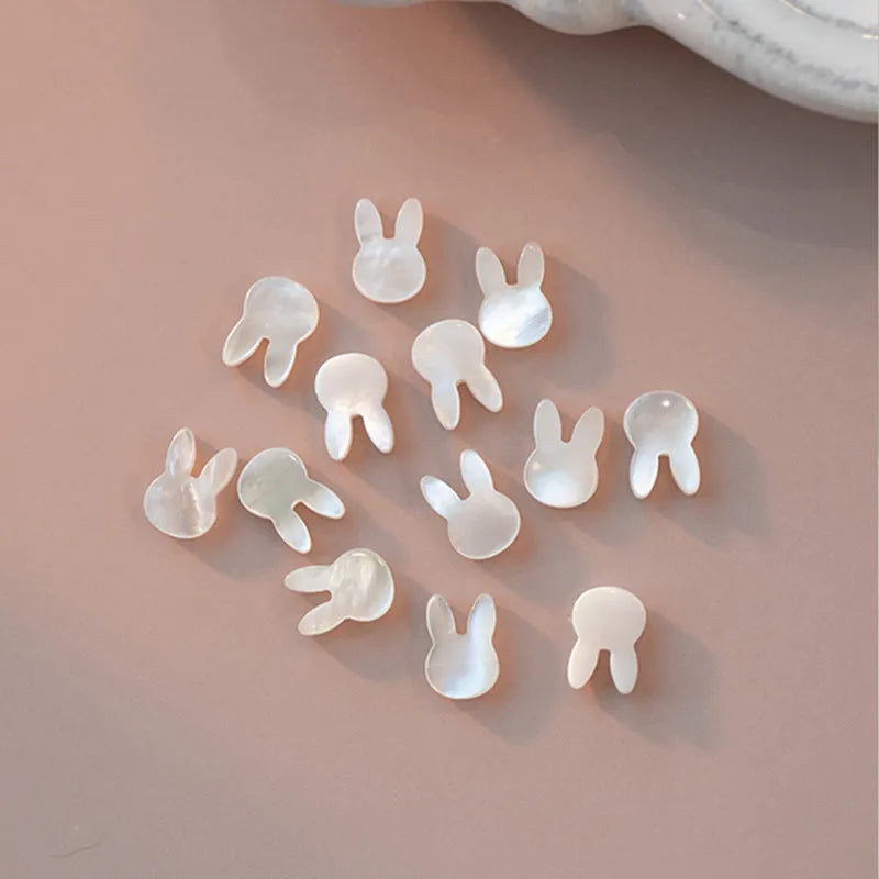 White shell small rice-shaped beads pearl elastic string rabbit bracelet 16cm handmade 925 silver on white background