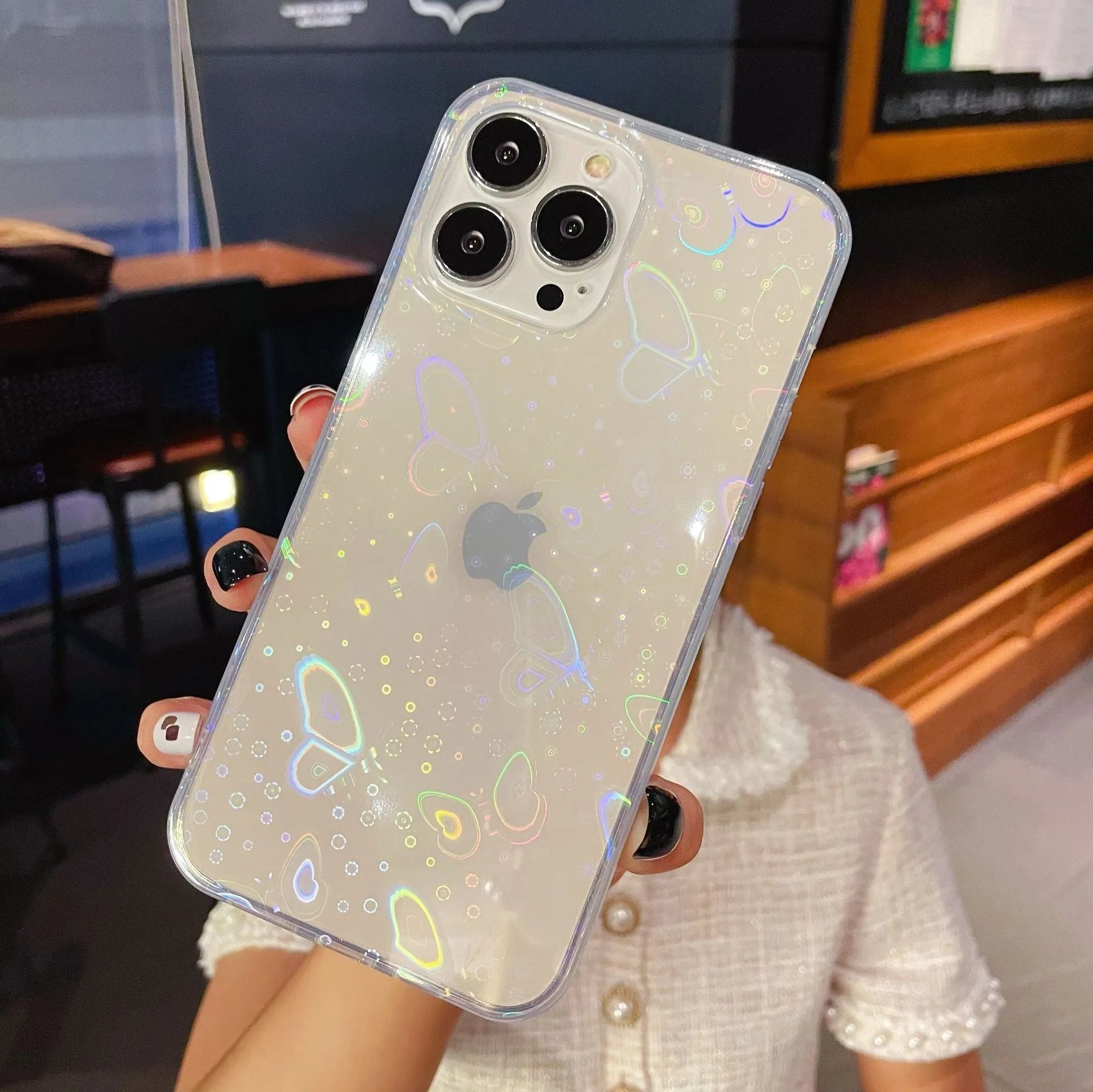 Transparent silicone iPhone case with laser colourful love design shown on an iPhone