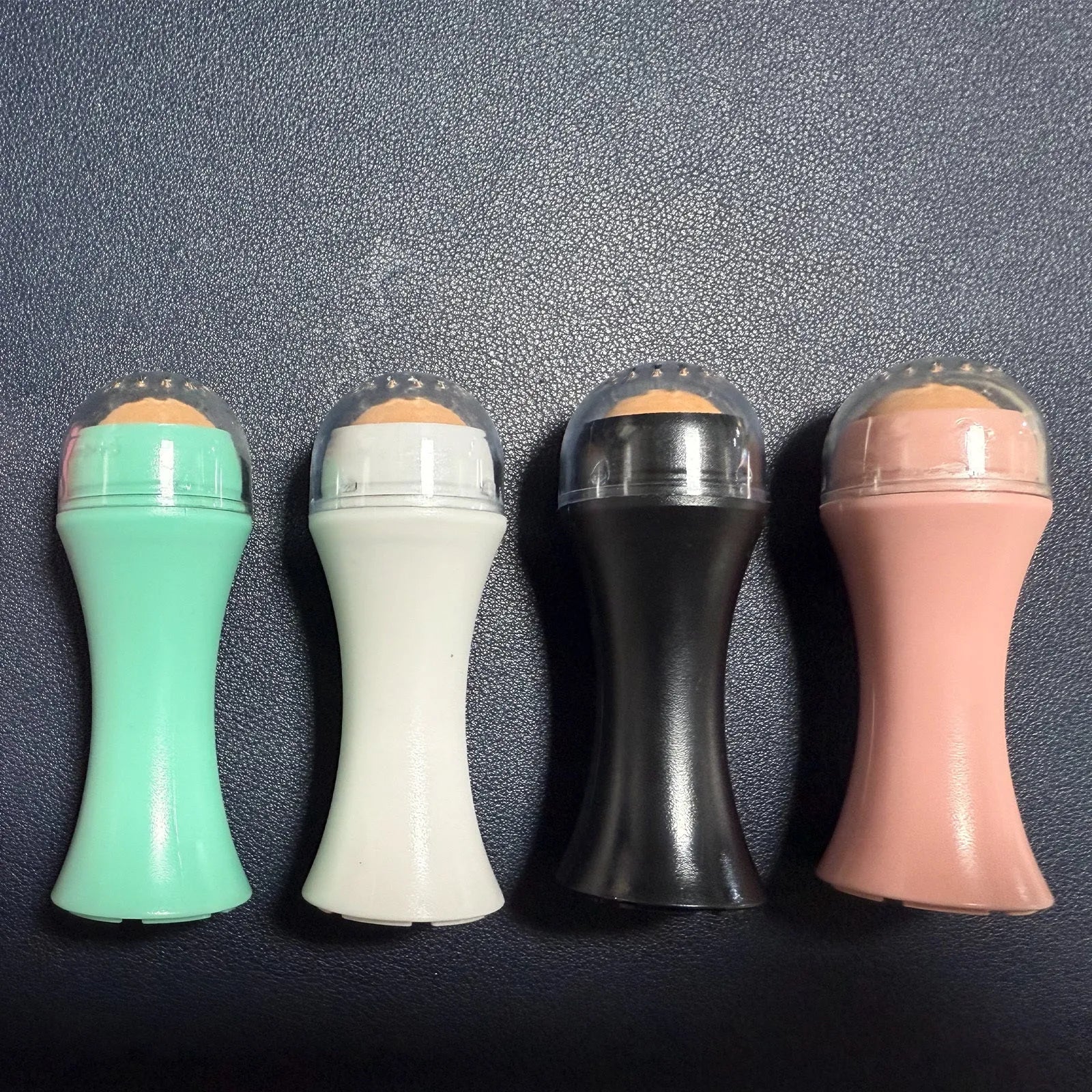 Volcanic portable roller for oily skin control in black, green, pink or white colour options