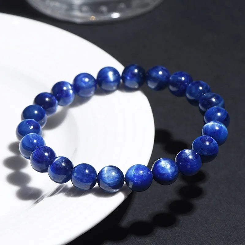 Natural grade 7A blue crystal ball bracelet with geometric beads and a Ruyi charm on a white background.