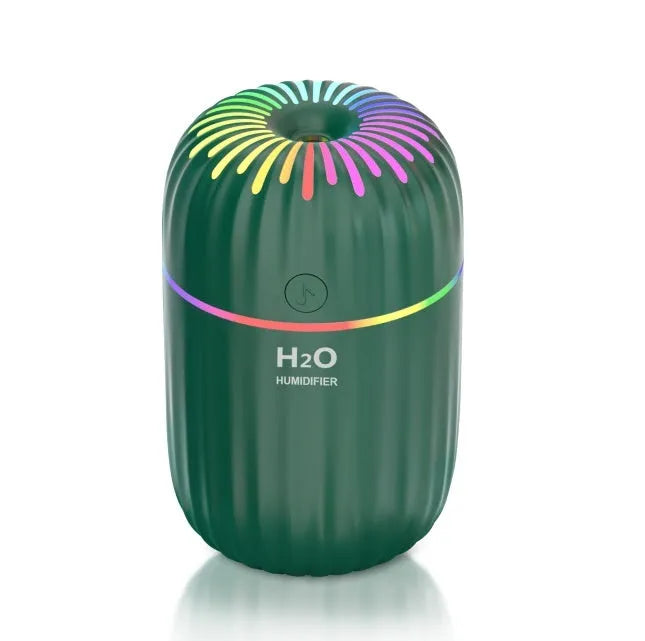 White USB mini humidifier with 300ml water tank on a desk next to a laptop