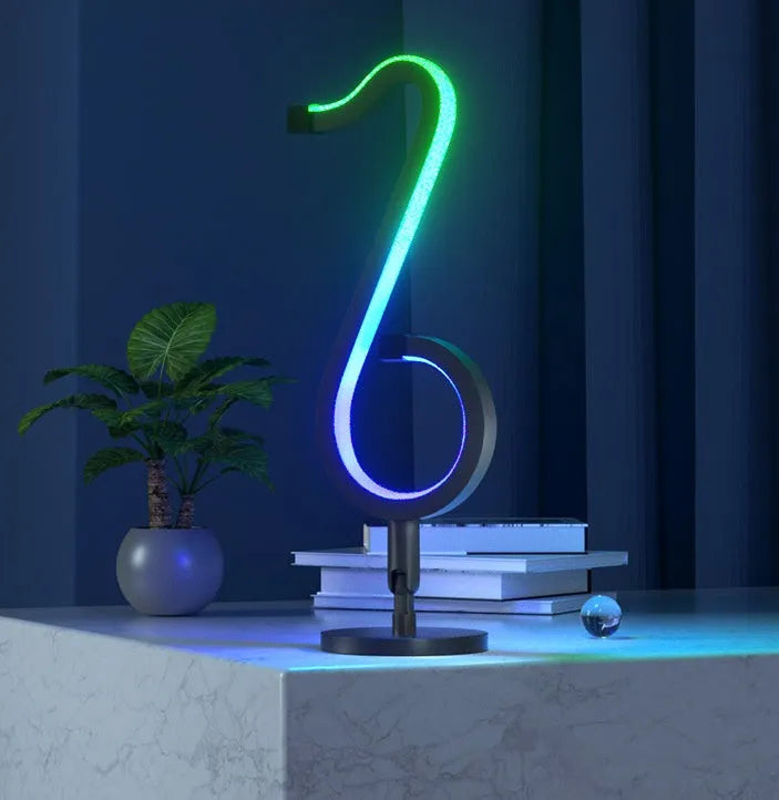 Black intelligent APP remote control LED atmosphere night light with 180 degree rotating chassis on a desk