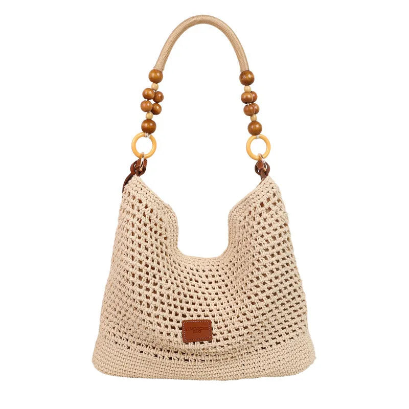 Knitted large capacity tote beach bag in bucket shape with contrast stitching and crossbody strap, black colour, on a plain background