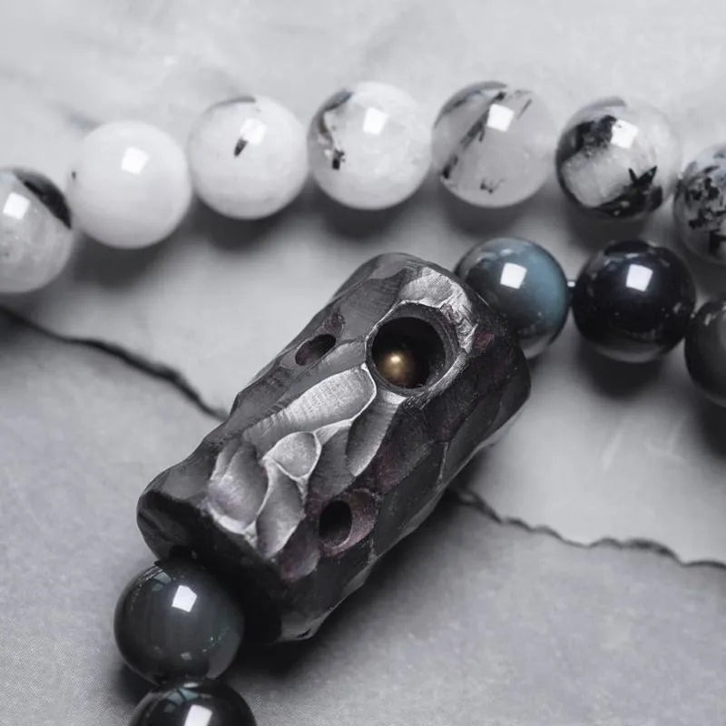 Ethnic style black hair crystal bracelet with white crystal tassel and bending lacing closure on plain background