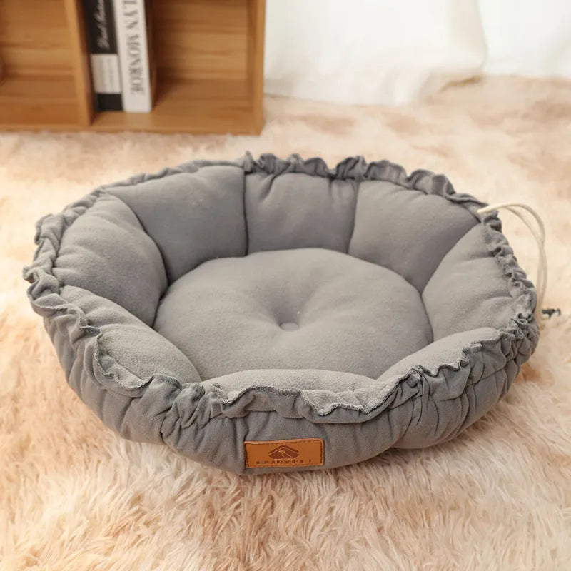 Grey reversible donut cat bed with raised edges shown alongside green version