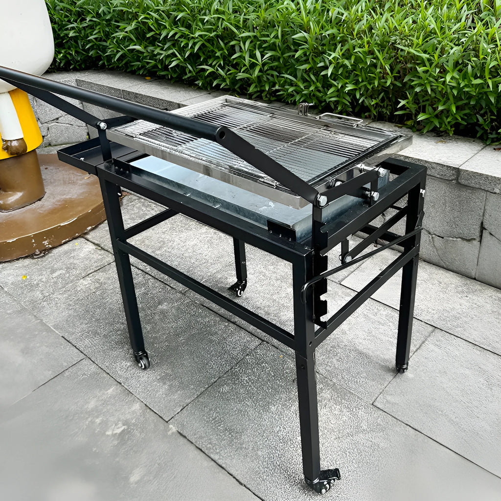 Large foldable Flip BBQ Stove charcoal barbecue grill set up in a garden.