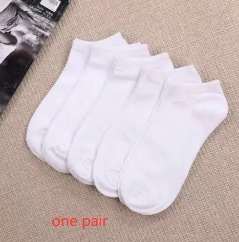 Black, white, and grey boat socks and medium tube socks from Degner in cotton blend fabric
