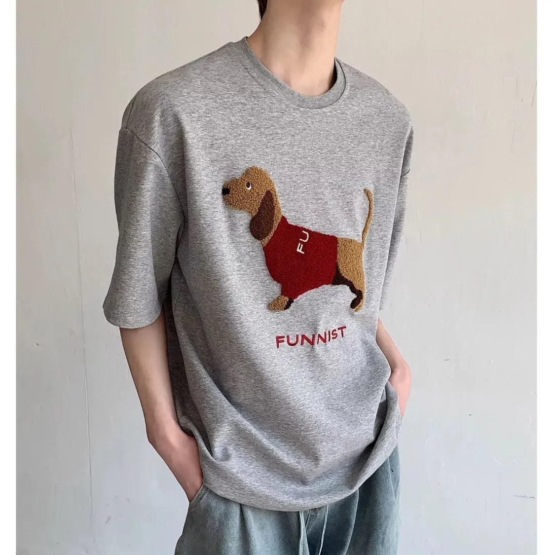 Grey men's short-sleeve cotton T-shirt with an embroidered sausage dog design on the chest.