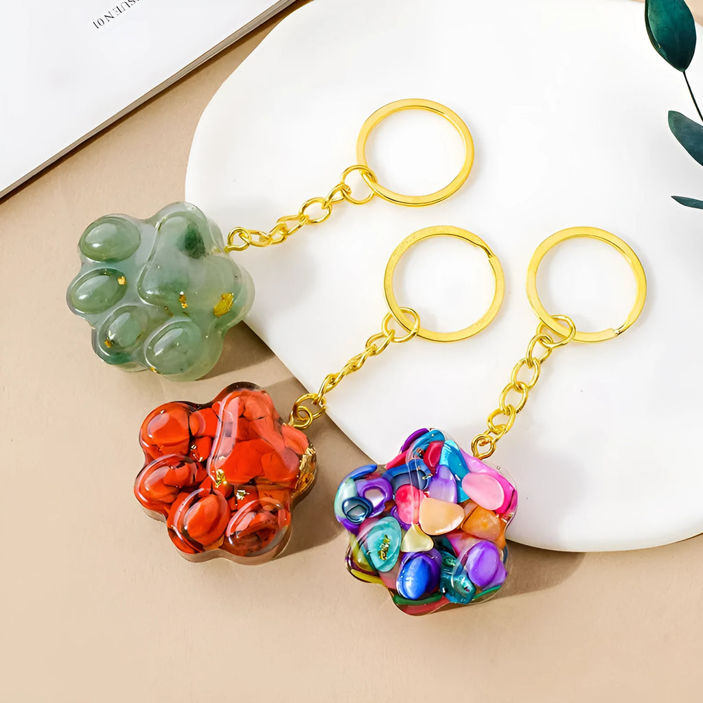 Natural crystal cat's paw keychain pendant in various gemstone colours including pink, red, green and blue variants