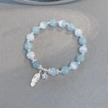 Small white girl crystal bracelet in feather XINGX blue moonlight with eight Awn star motif on wrist
