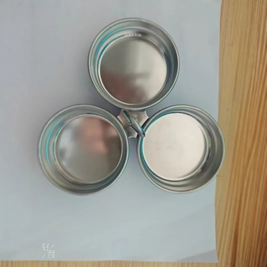 Small stainless steel heart-shaped egg steamer or round egg cooker for use on a hob.