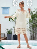 Apricot coloured hand-crocheted women's beach dress on a hanger