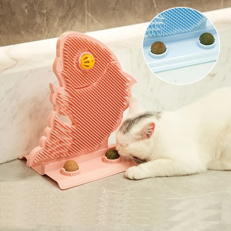 Blue fish-shaped cat wall scratcher with self-grooming brush and two green catnip balls on a base
