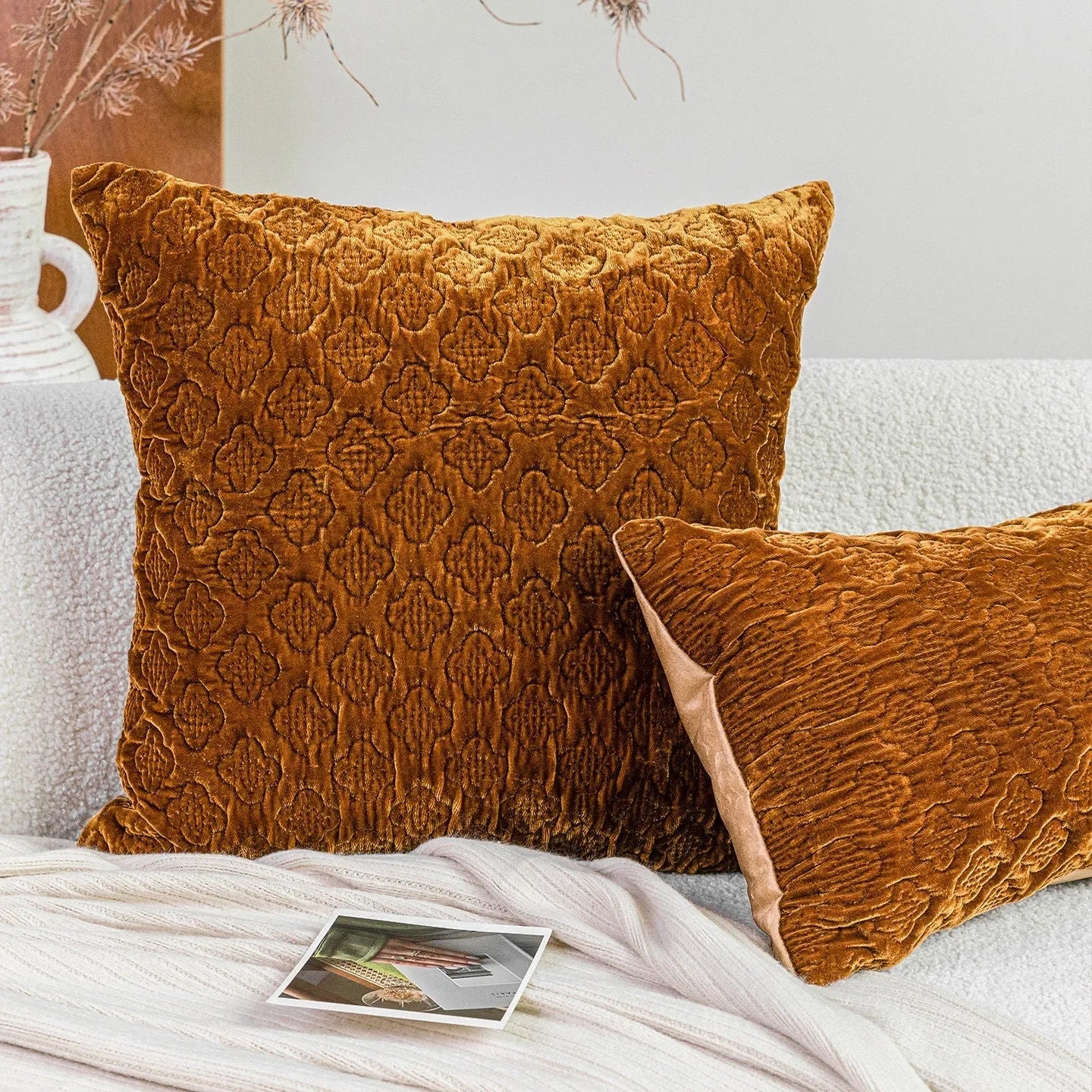 Brown gold antique-style quilted square cushion pillow with three-dimensional texture on a chair.
