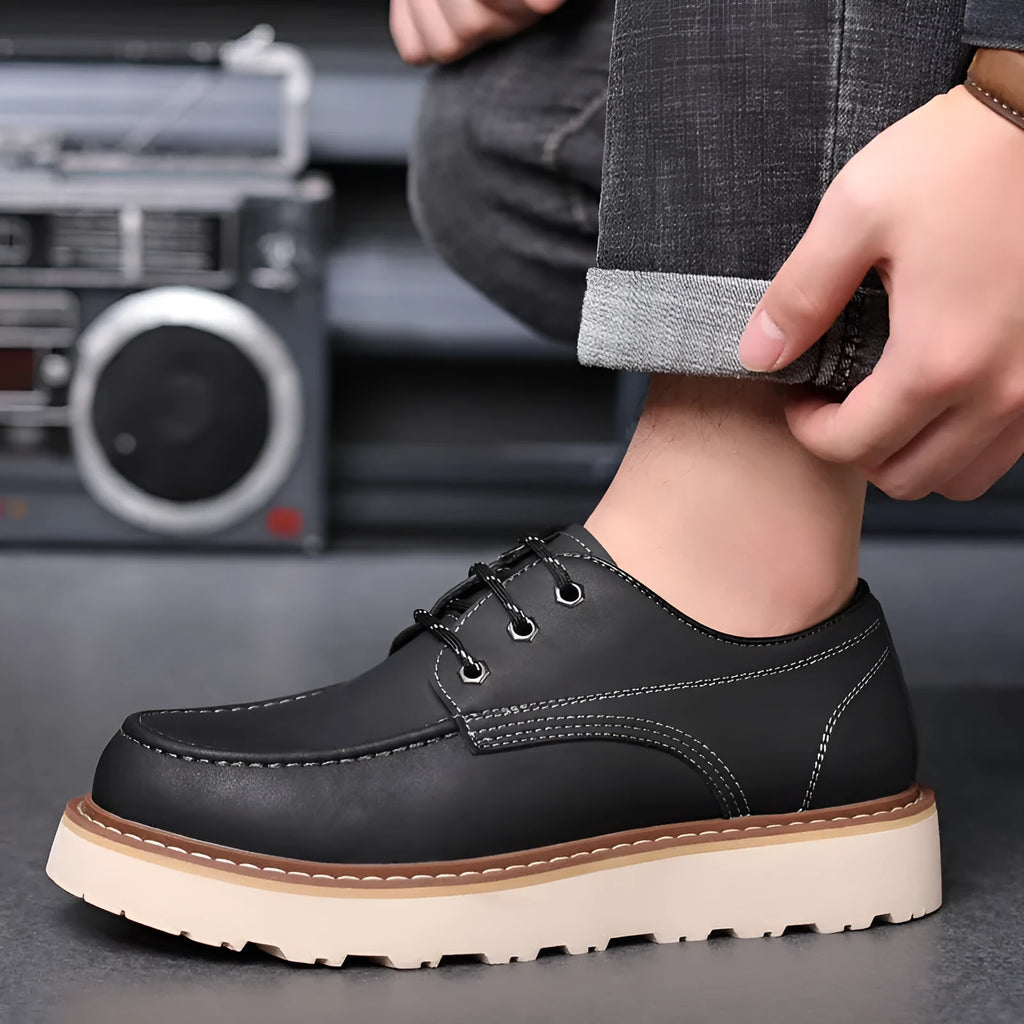 Men's black low top British retro worker boots with round toe and rubber sole.