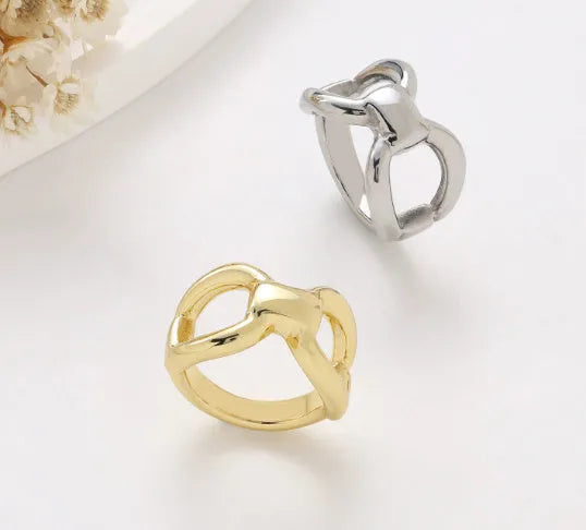 Titanium steel butterfly hollow ring in gold colour on a white background