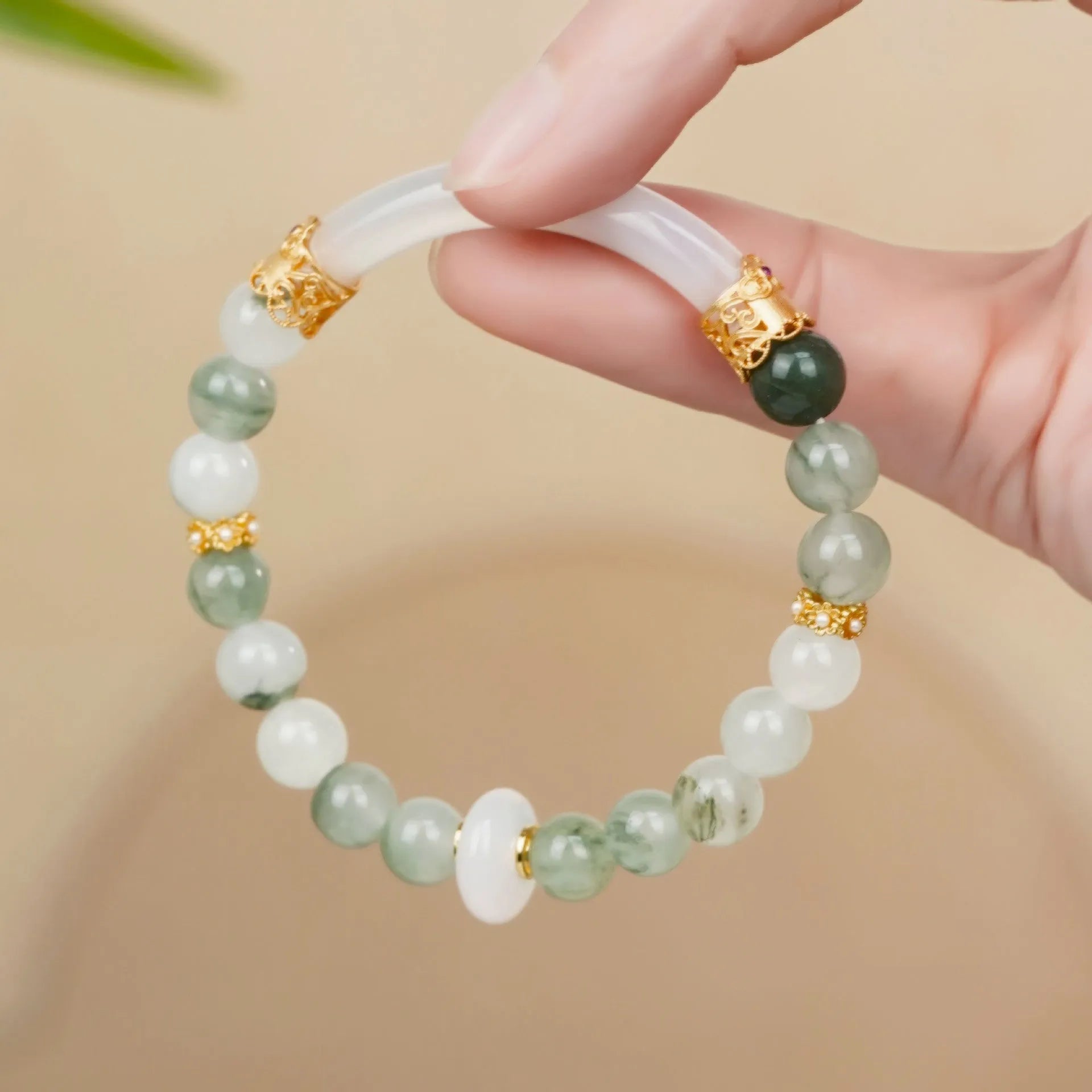 Light green emerald Tian Shan Cui half bracelet with floating flower girl motif on white background
