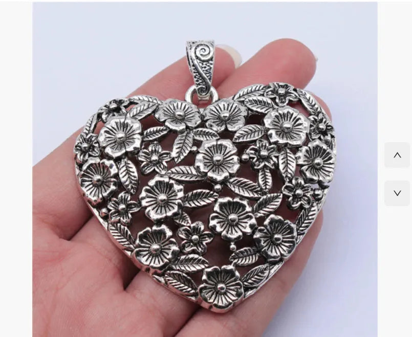 Hollow flower love pendant in ancient silver alloy finish, 67x58mm, on white background