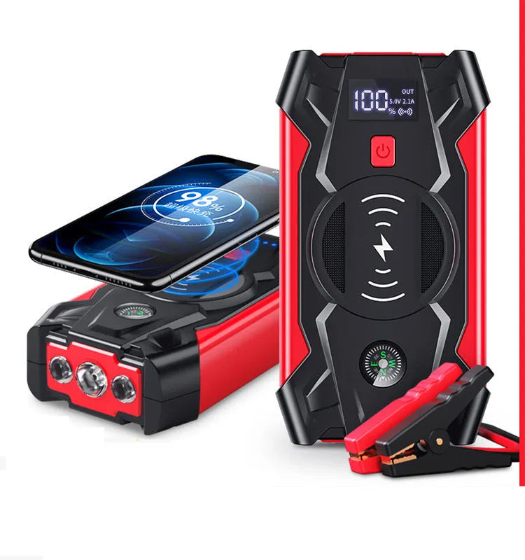 Compact red car battery jump starter unit with cables and clips on a dark background.