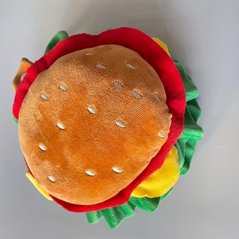A cat wearing a soft, colourful burger hat collar as an alternative to a plastic cone.
