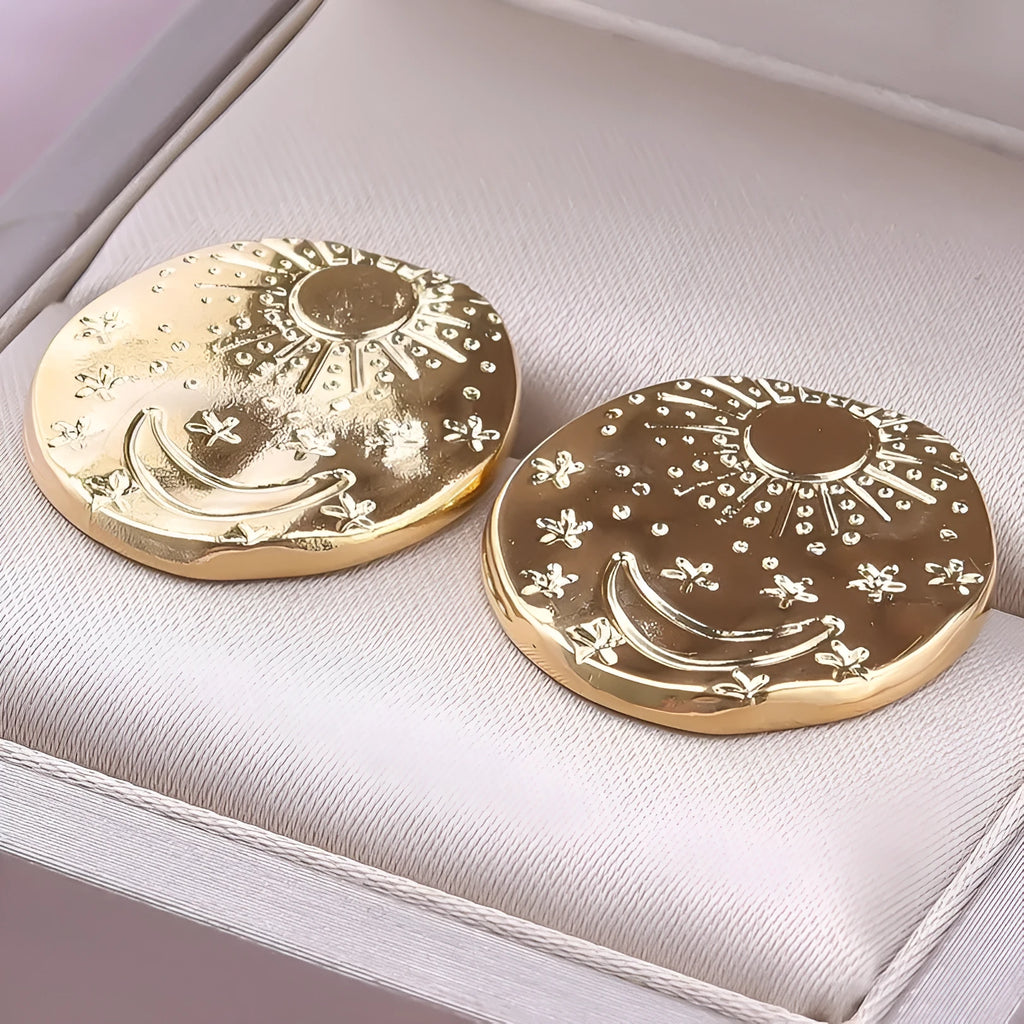 A pair of geometric shell-shaped stud earrings in 304 stainless steel with a gold or silver electroplated finish.