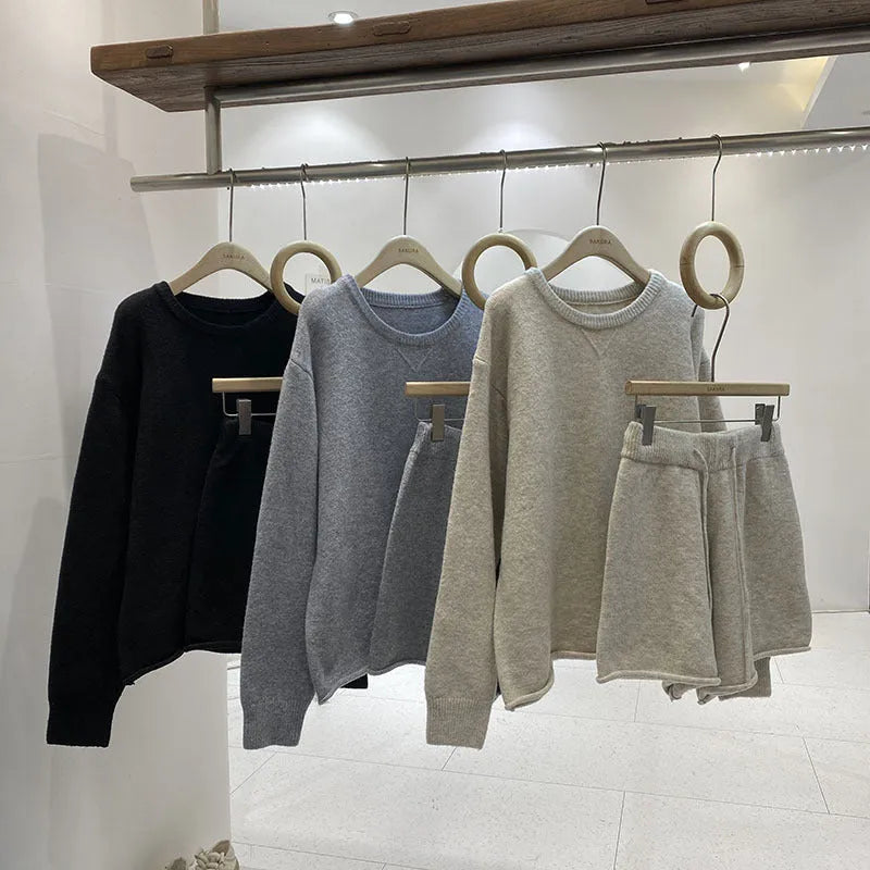 Women's loose-fitting long sleeve sweater and knitted wide-leg shorts co-ord set in dark grey.