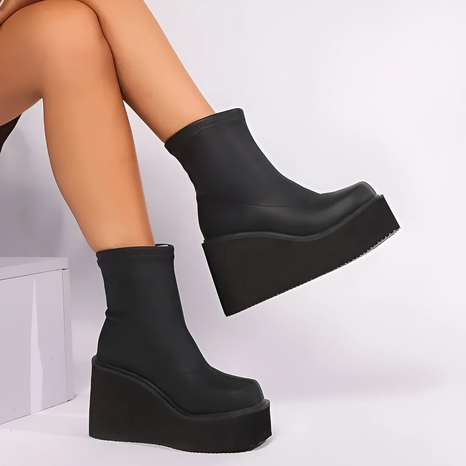 Black plus size women's wedge heel boots with a round toe and high cylinder shaft.