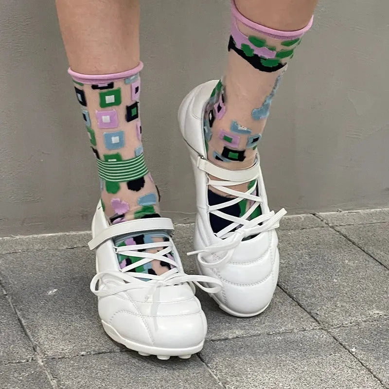 Women's silver lace-up sports shoes with a bow on the front, round toe, and leather stitching details on the microfiber upper.