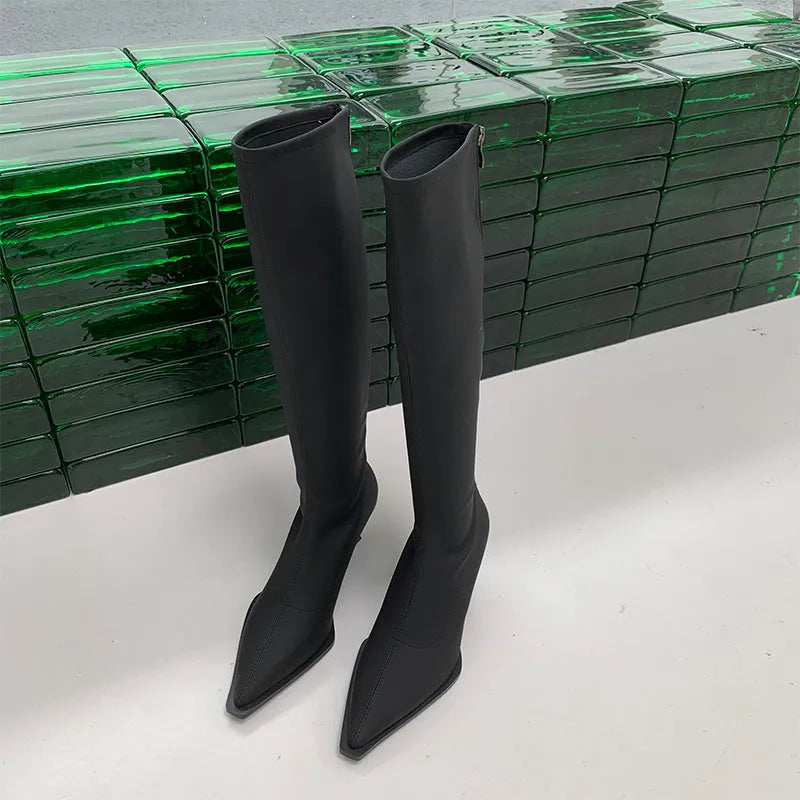 Black pointed toe women's below-the-knee stiletto boots with a back zipper on a white background