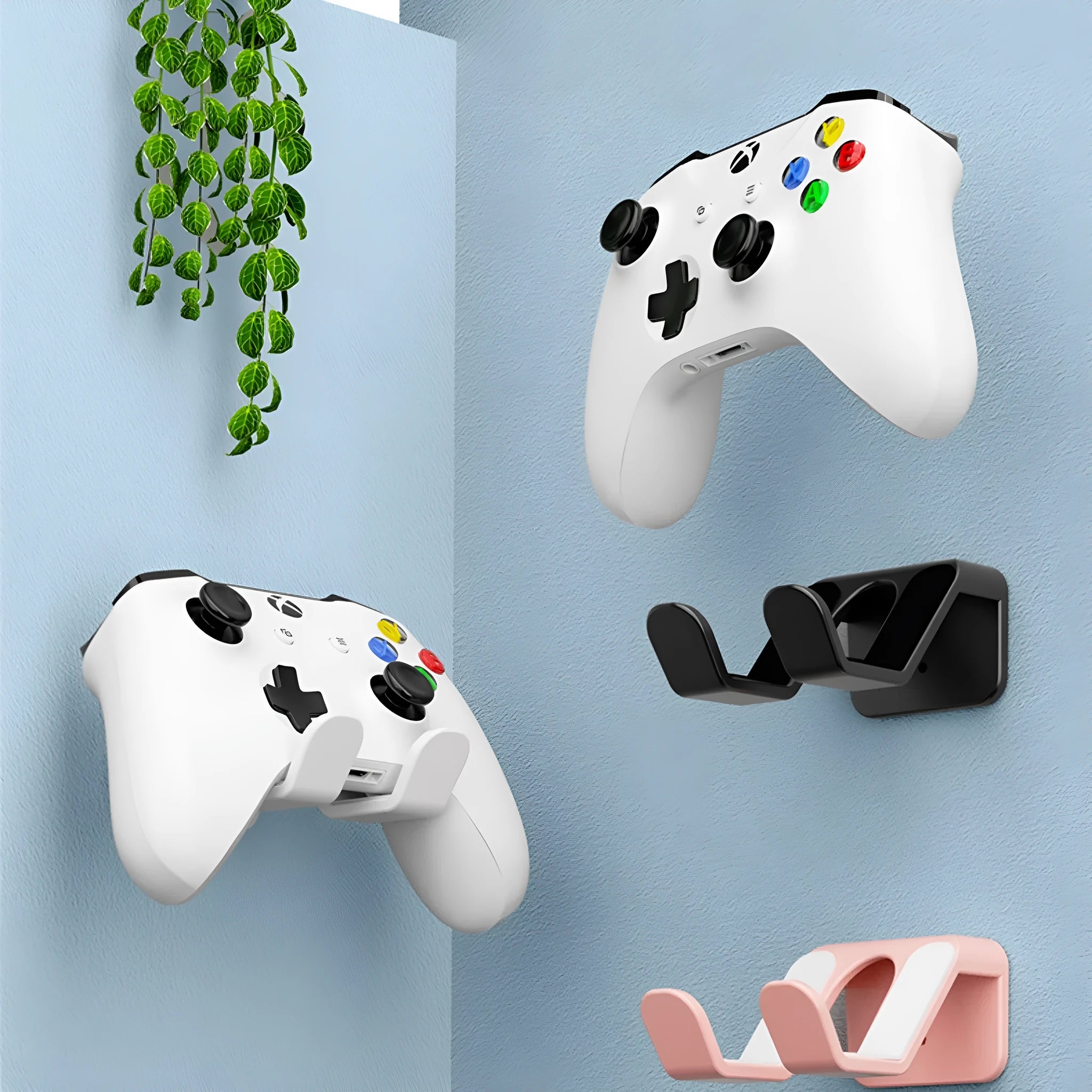 Black universal wall hanging rack for game controllers with non-perforated handle and adhesive mount.