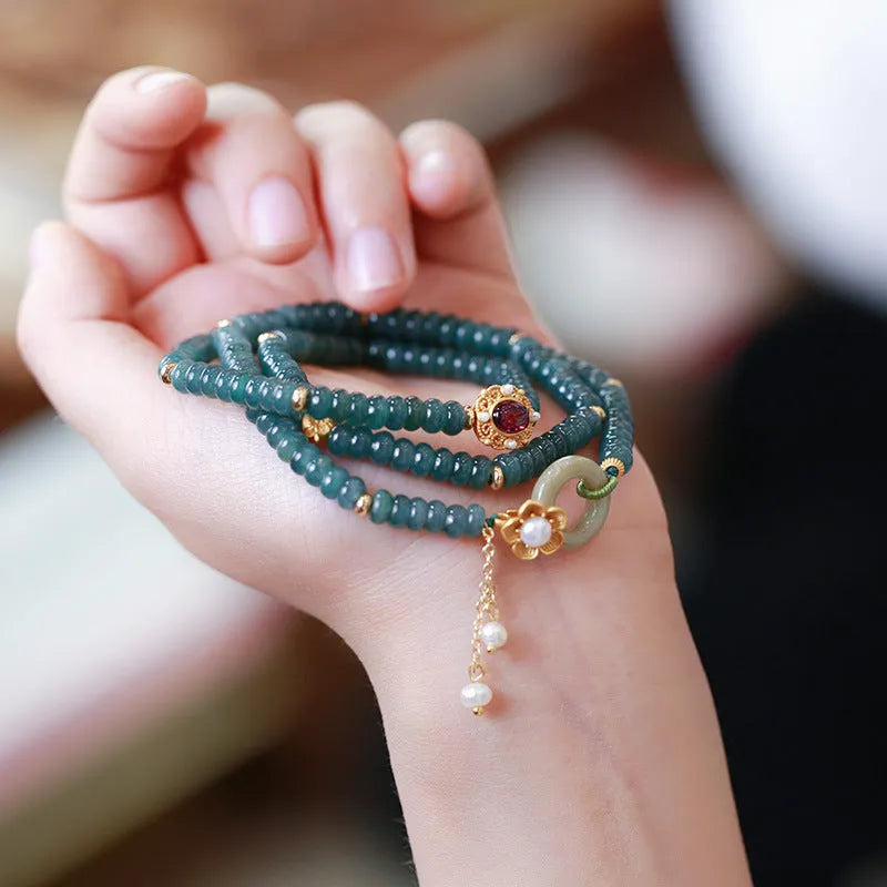 Blue water jade abacus beads bracelet with tourmaline and pearl three-ring design on wrist