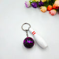 Mini PVC metal bowling ball keychain pendant in blue, dark red, green, or purple.