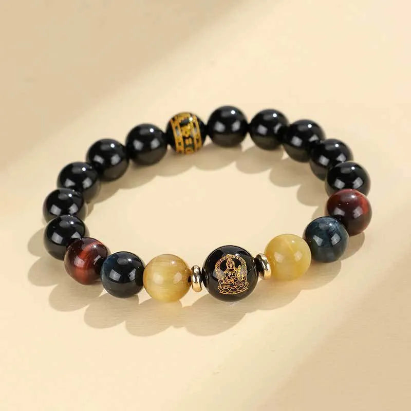 Black agate beaded bracelet with tiger eye stones in ethnic style on plain background