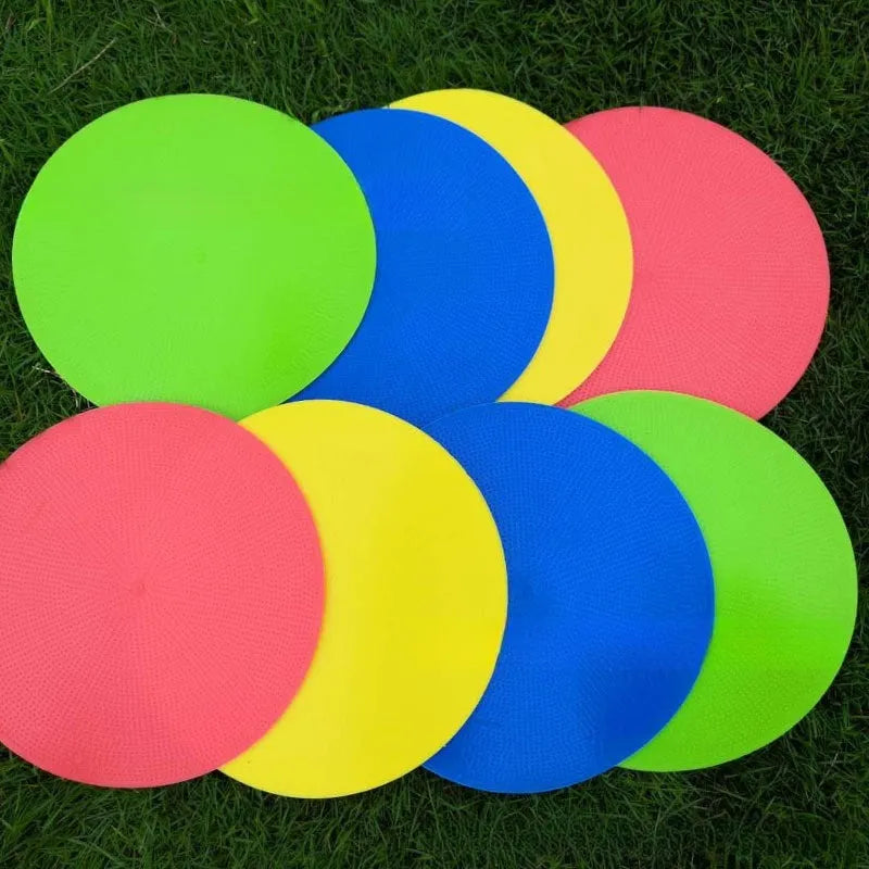 Flat circular yellow football training landmark pad on grass, 23cm diameter