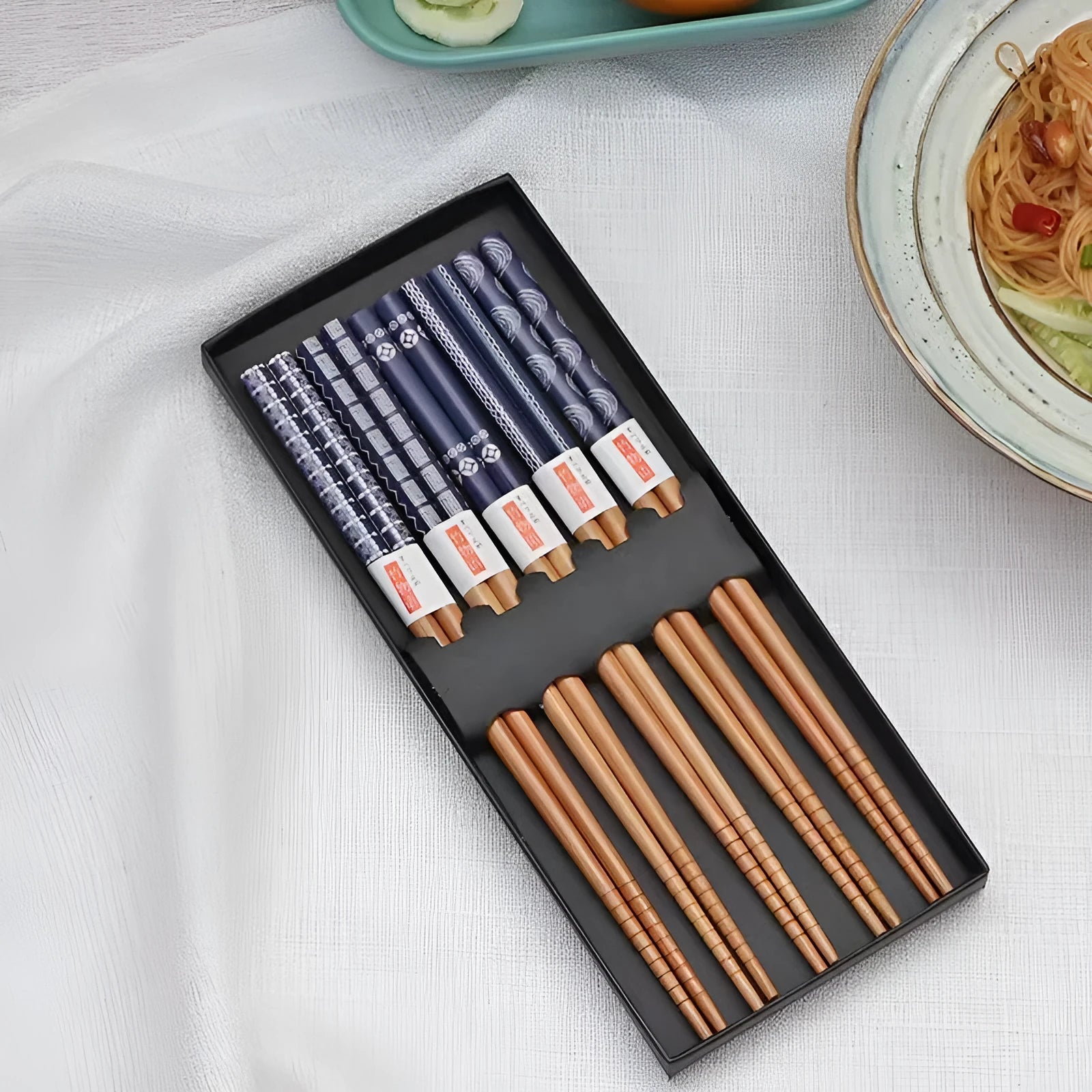 Five pairs of bamboo chopsticks with colourful Japanese lucky cat cartoon design.