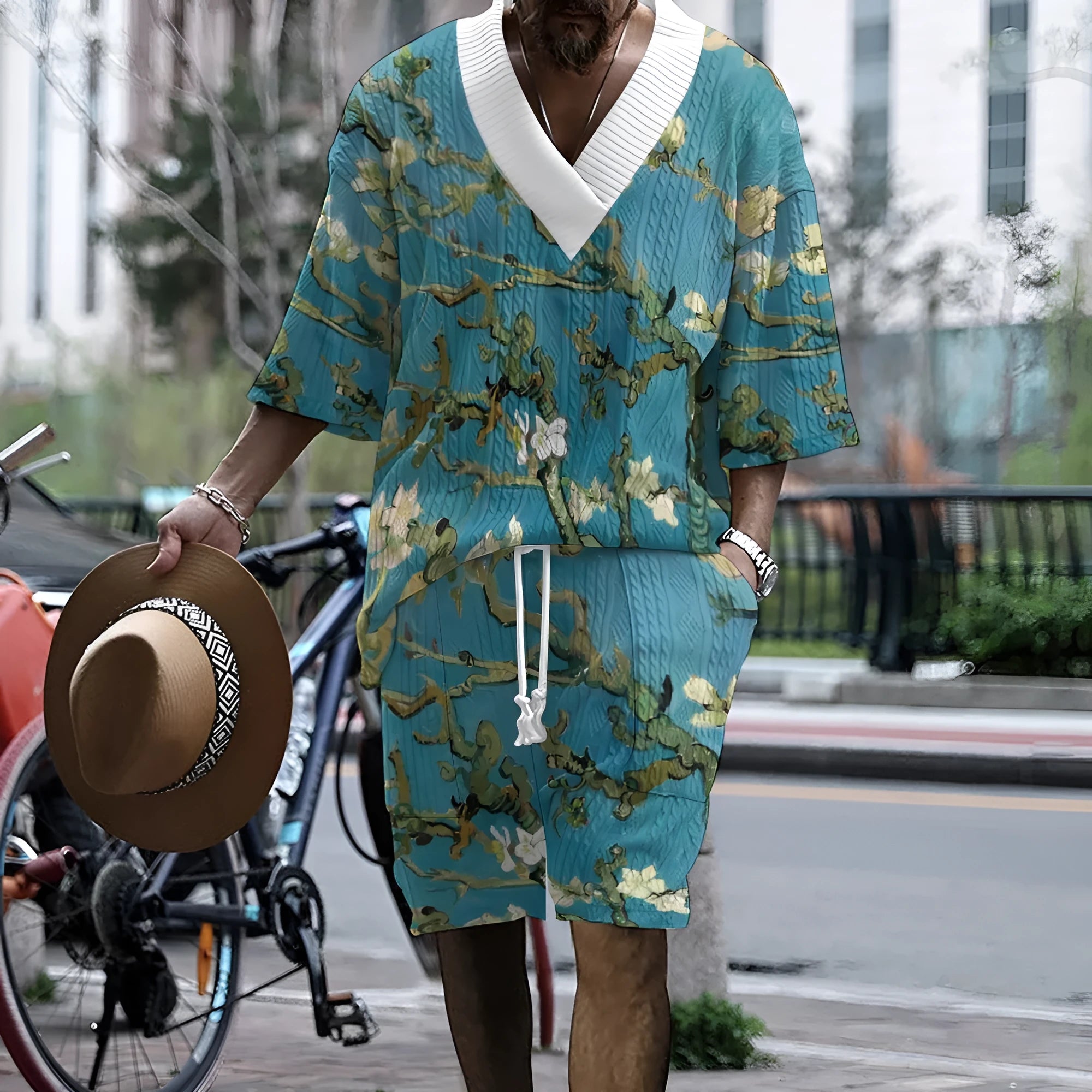 Men's peacock blue 3D printed knitted shorts suit with matching t-shirt, laid flat.