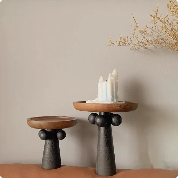 Nordic style wooden tray with four raised legs holding candles and aromatherapy bottles