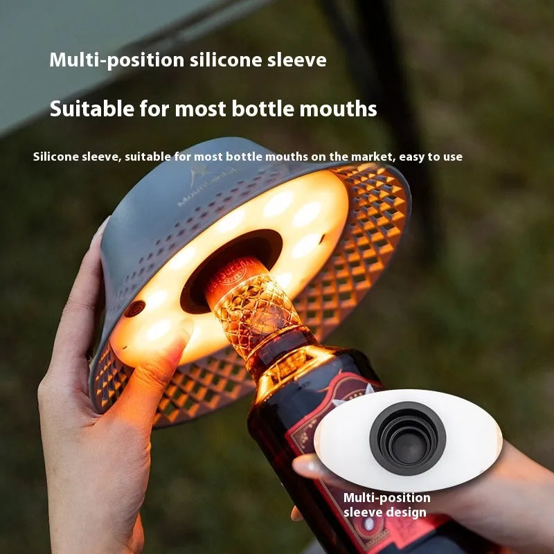 Beige and grey wine bottle shaped camping lantern with USB-C port showing three light mode options